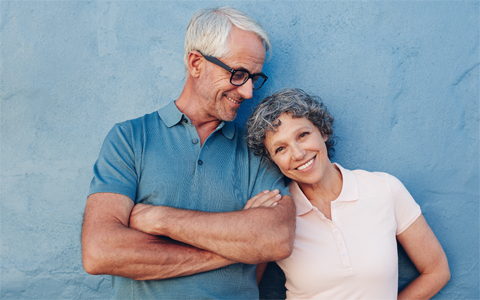 Husband and wife with shining bright white teeth thanks to professional teeth whitening in San Luis Obispo.