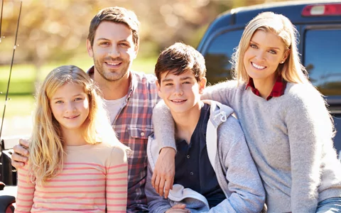 Woman shows off her new prepless porcelain dental veneers in front of her family in San Luis Obispo.